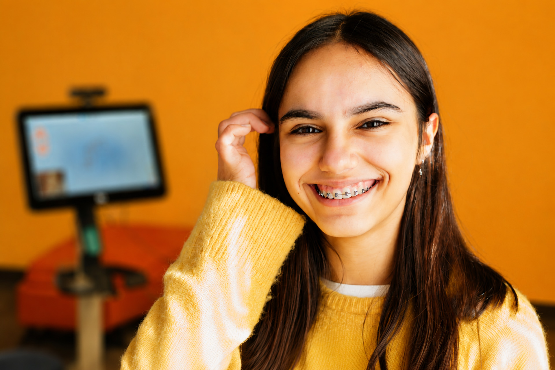 Teen Girl With Braces Smiling At Camera With Ring Light