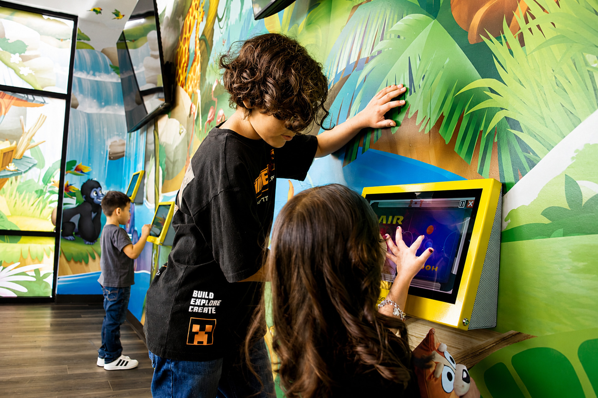 Two Kids Playing Interactive Jungle Wall Games